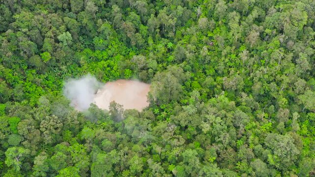 Aerial drone of lake near the Apo volcano in a rainforest in the mountains. Lake Agco, Mindanao, Philippines. Mud lake in the rainforest.