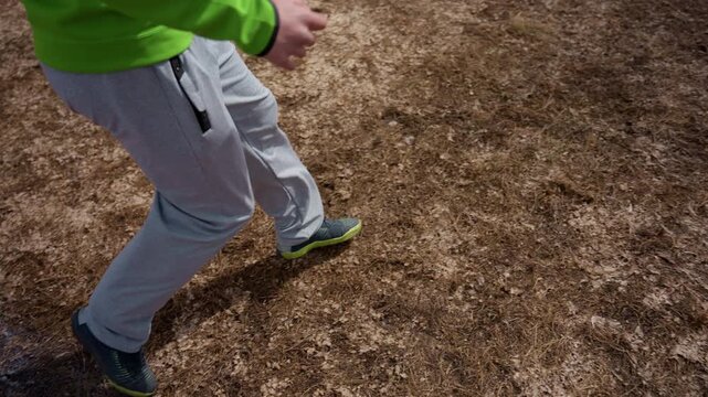 controlled pass with poised stance on dry field, player preparing follow-through and measured delivery; calm training cadence, close-up of foot placement and ball arc, cinematic everyday sport moment