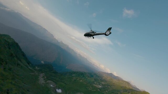 FPV drone follow shot black air transportation flying over greenery ridge at sunrise. Picturesque natural wild scenery sunset cloudy sky with aviation vehicle