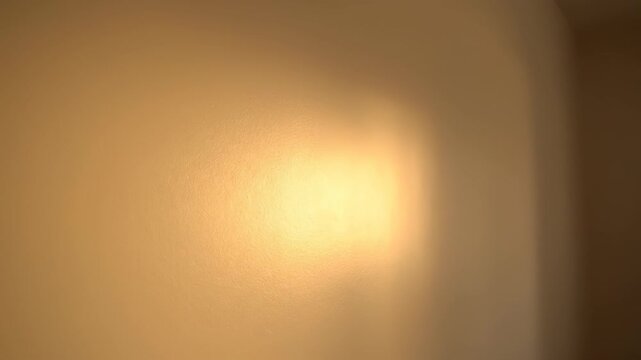 Warm Light on Textured Wall: Capturing the gentle interplay of light and texture on a neutral surface, evoking a sense of calm and visual interest. 