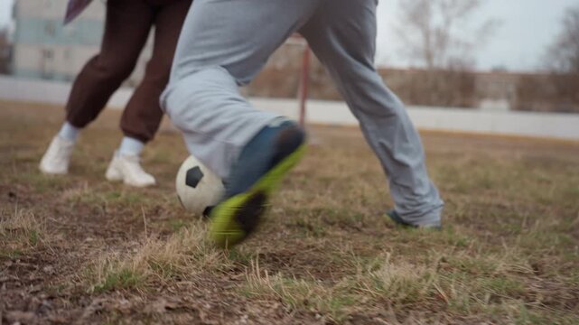 wet field footwear in action, moist ground with splashing shoes displaying vigorous athletic activity, damp turf emphasizes muddy footwear movement capturing energetic moments on field