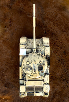Aerial view of a solitary tank, a metallic titan against the stark, textured earth, its turret casting shadows in the golden light, Eilat, South District, Israel.