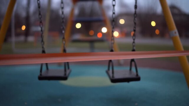 Empty Swings at Dusk Playground.