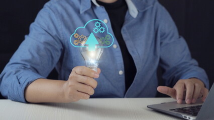 Cloud computing and innovation concept with light bulb and digital cloud upload icon. Technology development, data transfer, automation system and smart business solution for digital transformation.