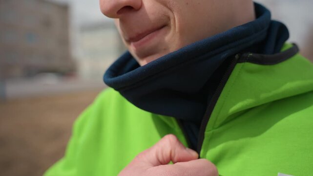 ensuring warmth with layered winter clothing gear, comfortably ready for cold weather outdoor exercise session, dressed appropriately with scarf and jacket to withstand winter outdoor training
