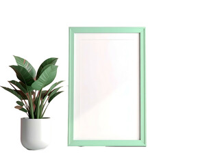 A pale green picture frame stands beside a potted green plant against a black backdrop
