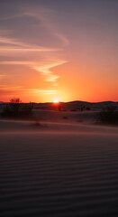 Obraz premium Majestic desert landscape bathed in the warm glow of a breathtaking sunset over serene sand dunes
