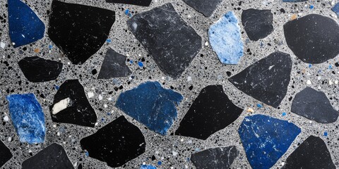 Colorful terrazzo flooring featuring a mix of black, gray, and blue stone fragments, showcasing unique patterns and textures, ideal for modern interior design and architectural applications