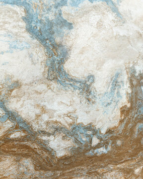 Aerial view of swirling patterns of beige, brown, and blue blending together like brushstrokes on a canvas, Iceland.