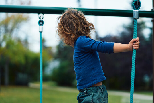 Young child on play equipment in the park