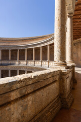 Fototapeta premium Granada, Spain, Andalusia - March 23, 2025: Circular patio of Palace of Charles V, renaissance building inside fortress Alhambra, former Nasrid palace complex