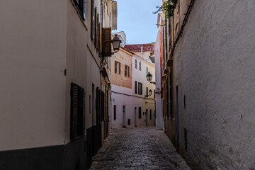 Obraz premium Narrow cobblestone alley in Ciudadela, Menorca, Balearic Islands, Spain, inviting exploration