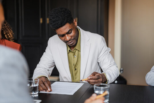 Man signs a business document
