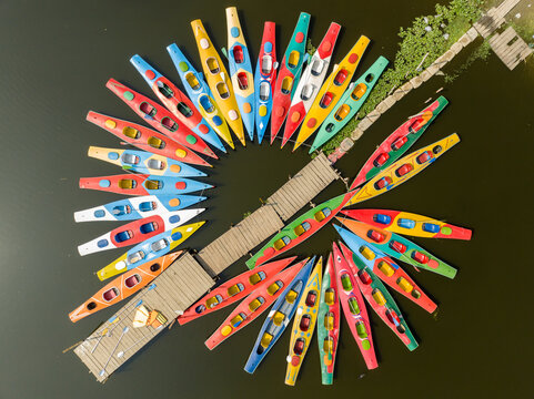 Aerial view of a vibrant array of colorful kayaks arranged around docks on the still water, Dhaka, Dhaka Division, Bangladesh.
