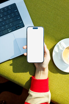 Phone Mockup with White Screen on Green Surface