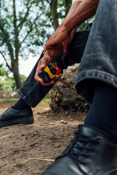 Man Holding a Disposable Film Camera in a Natural Setting