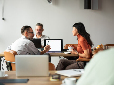Business Meeting Among Colleagues With Laptops and Coffee