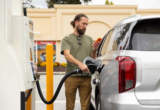 Man pumping gas car  gasoline at station 