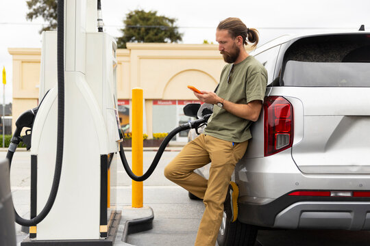 Man pumping petroleum gasoline at station 