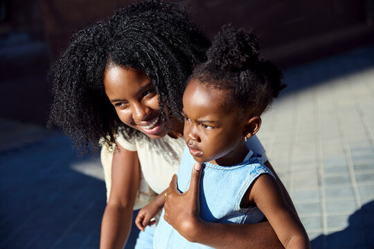 Mother comforting daughter before school