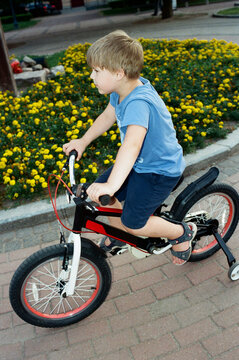 Child rides a bicycle on a sunny day