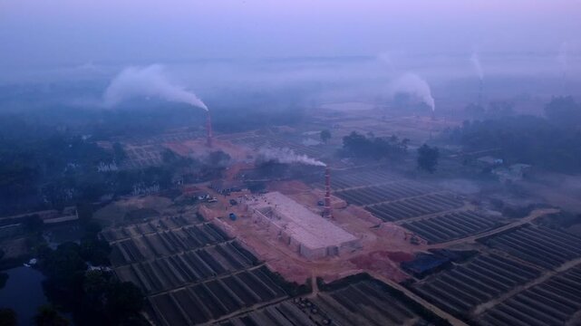 Aerial Drone View of Brick Kiln Factory Air Pollution in Foggy Rural Bangladesh Landscape