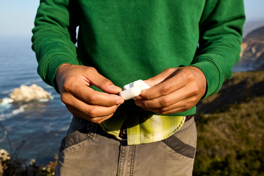 Anonymous man uses wireless earphones
