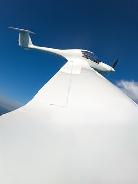 Small Airplane Banking In Clear Blue Skies