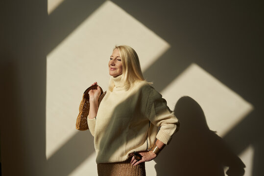 Senior enjoys sun rays while wearing knitted clothing