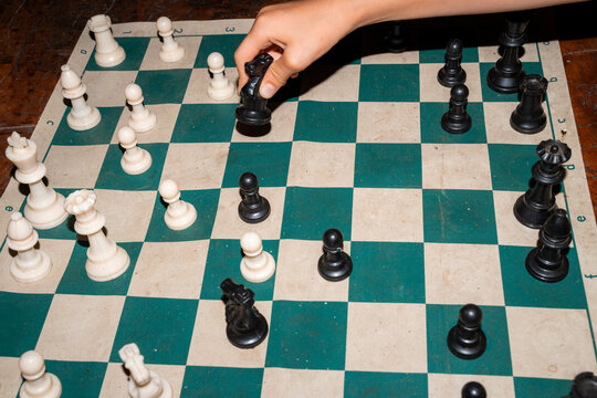 Chess Match in Progress on Wooden Table