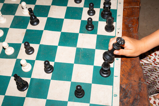 Chess Match in Progress on Wooden Table