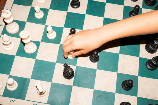 Chess Match in Progress on Wooden Table