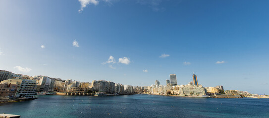Fototapeta premium View across Balluta Bay showcasing the modern skyline of St. Julians in Malta