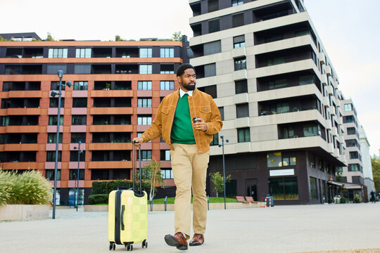Fashionable man strolls with a suitcase