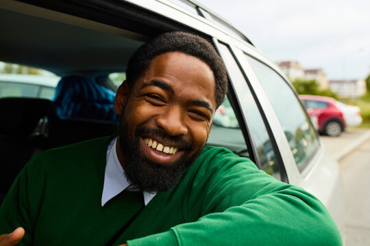 Happy man drives his car