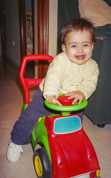 UGC photo of one year old baby on tricycle at home