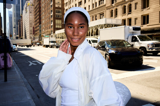 Woman walks across the street in NYC