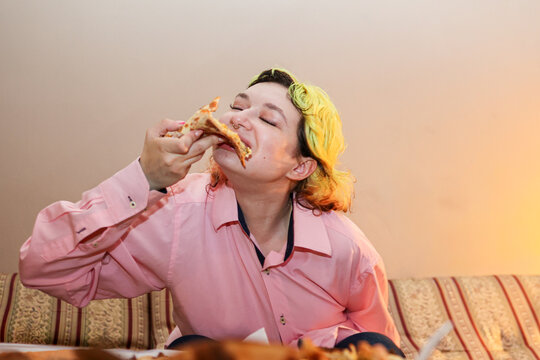 Eating a Slice of Pizza at Home and enjoying 