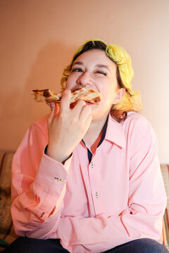 Girl Enjoying a Slice of Pizza at Home 