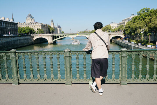 Man looking at the Seine river in Paris