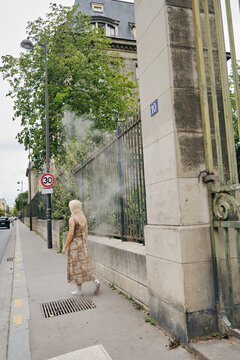 Woman walking in the streets of Paris with smoke 