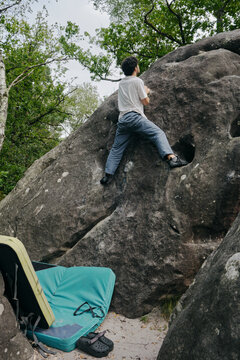 Man climbing a boulder in France