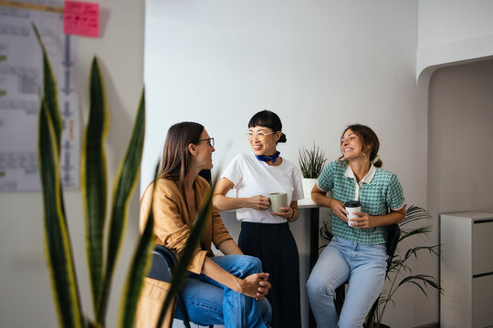 Three Smiling Women Having a Coffee Break From Work