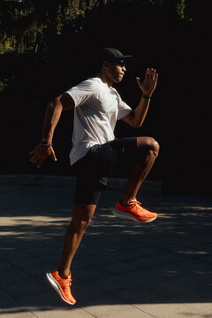 a young man doing stretching in a park