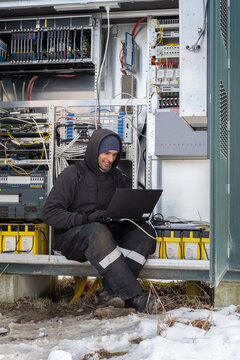A technician on fieldwork maintains telecommunication Equipment 