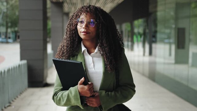 Confident African American business woman walking in office empowered female executive enjoying successful corporate career