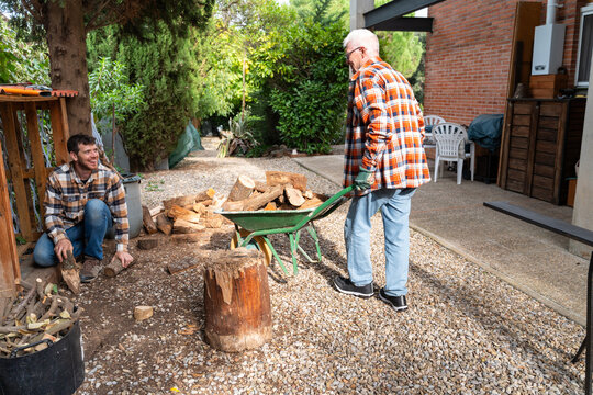 Father and Son Stacking Firewood