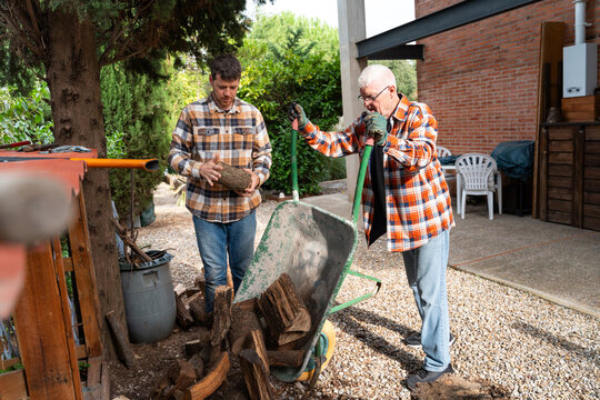 Father and Son Stacking Firewood