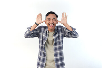 Fototapeta premium Asian man wearing a plaid shirt with a playful expression is making a funny face on an isolated white background.
