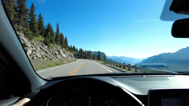 Driver&rsquo;s View of Winding Mountain Road with Scenic Valley